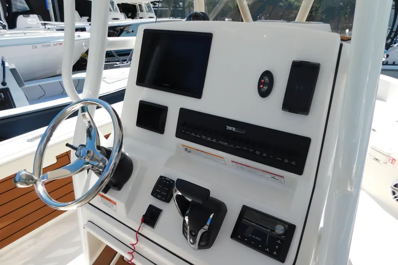 Slide: The Image of 2026 Pathfinder 2400 TRS boat console with steering wheel and electronic controls. - 3