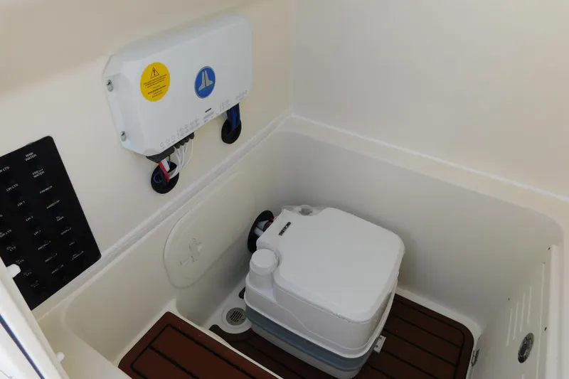 Slide: The Image of 2026 Pathfinder 2400 TRS boat interior with portable toilet and control panel. - 35