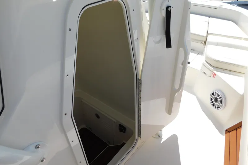 Slide: The Image of 2026 Pathfinder 2400 TRS boat interior with open storage compartment and seating area. - 38