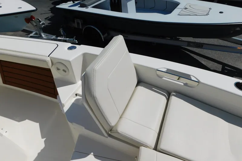 Slide: The Image of 2026 Pathfinder 2400 TRS boat interior with white seating and sleek design. - 6