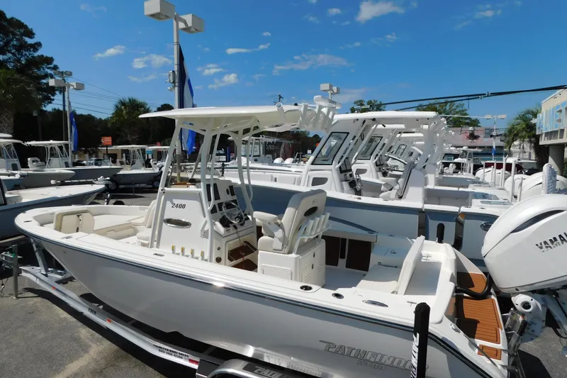 Slide: The Image of 2026 Pathfinder 2400 TRS boat displayed at a dealership under a clear blue sky. - 8