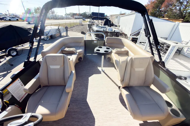 Slide: The Image of 2026 Godfrey Sweetwater Xperience 22' Tritoon with split bench seating and modern interior design. - 14