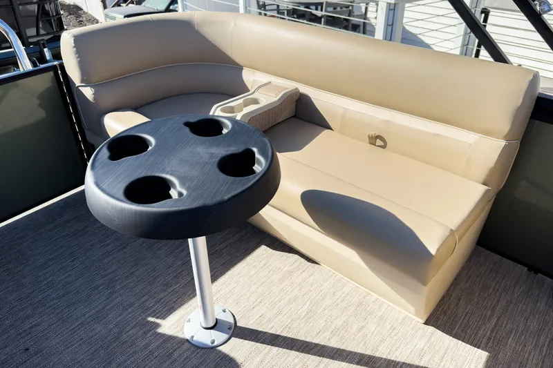 Slide: The Image of Luxurious seating on 2026 Godfrey Sweetwater Xperience 22' Tritoon with cup holder table. - 22