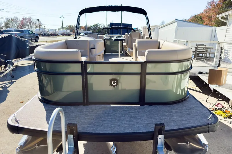 Slide: The Image of 2026 Godfrey Sweetwater Xperience 22' Tritoon with split bench seating, docked outdoors. - 3