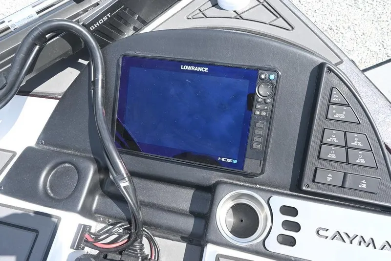 Slide: The Image of 2026 Caymas XS 21 boat dashboard with Lowrance HDS12 display and control panel. - 3