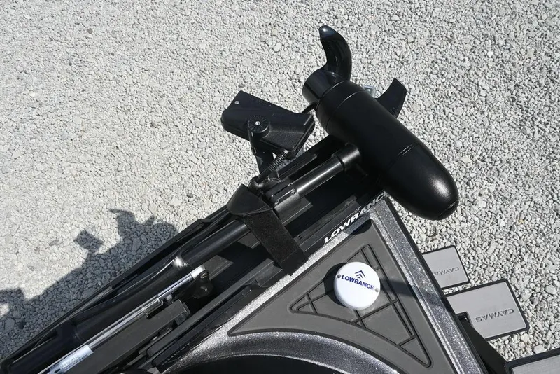 Slide: The Image of Caymas XS 21 boat equipment featuring Lowrance technology, 2026 model, on gravel surface. - 8