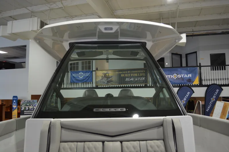 Slide: The Image of 2026 Monterey Elite 27 SD boat interior at a showroom display. - 14