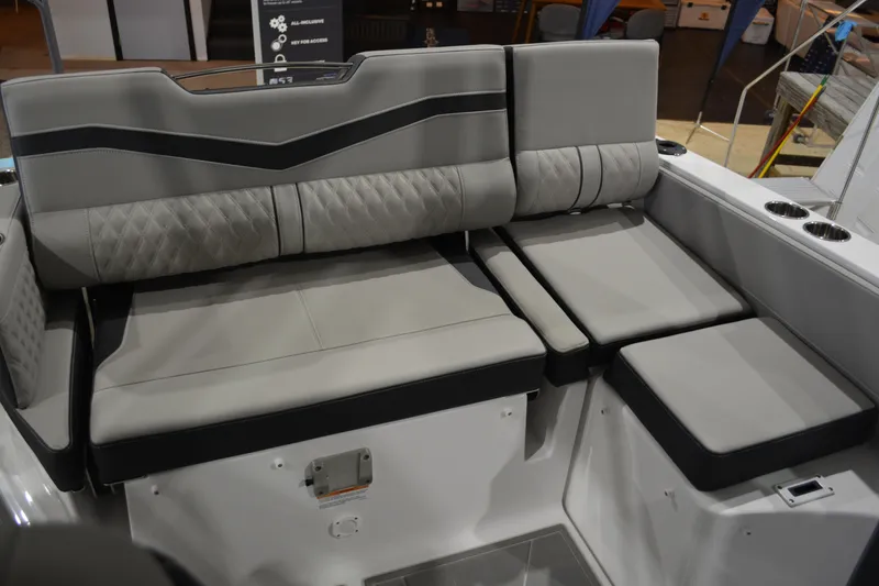 Slide: The Image of Luxurious seating on 2026 Monterey Elite 27 SD boat, featuring elegant gray upholstery. - 23