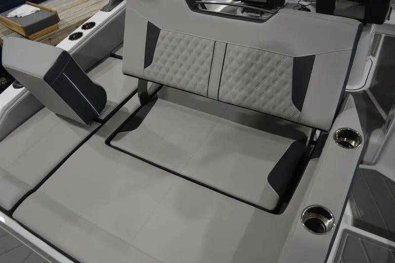 Slide: The Image of 2026 Monterey Elite 27 SD boat interior with luxurious seating and cup holders. - 24