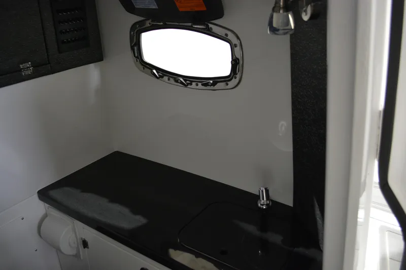 Slide: The Image of Interior of 2026 Monterey Elite 27 SD boat, featuring a sleek countertop and window. - 26
