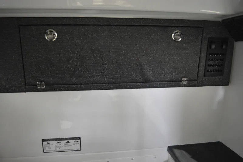 Slide: The Image of 2026 Monterey Elite 27 SD interior storage compartment with sleek black finish and secure latches. - 27