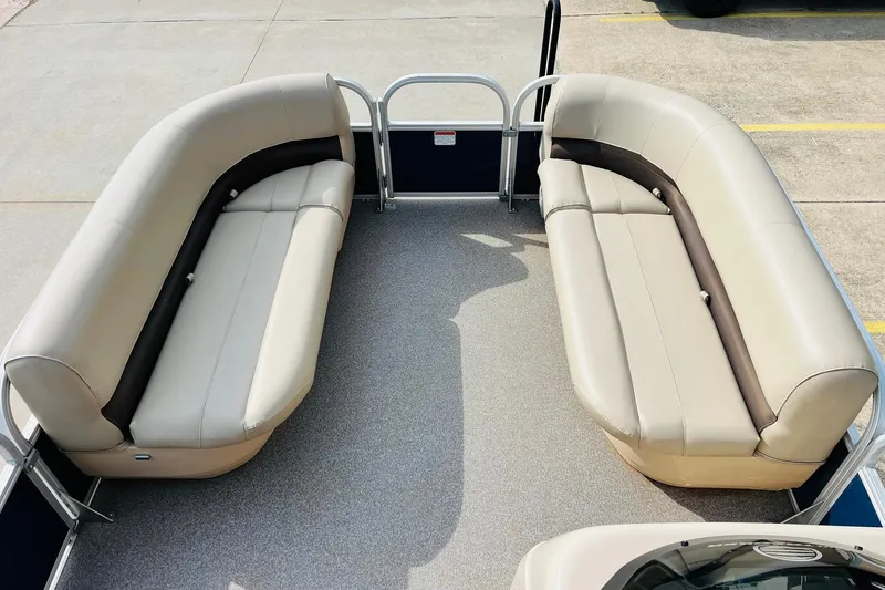 Slide: The Image of 2019 Sun Tracker Party Barge 18 DLX interior with beige seating and spacious layout. - 12