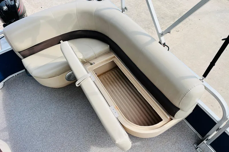Slide: The Image of 2019 Sun Tracker Party Barge 18 DLX with open storage compartment under beige seating. - 23