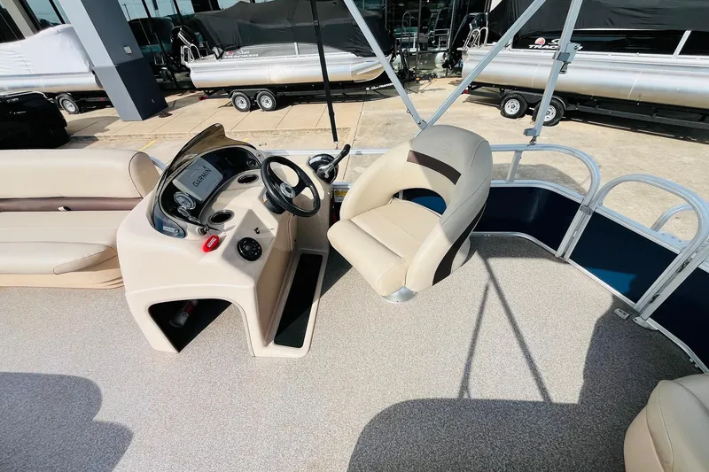 Slide: The Image of 2019 Sun Tracker Party Barge 18 DLX interior with steering console and seating. - 25