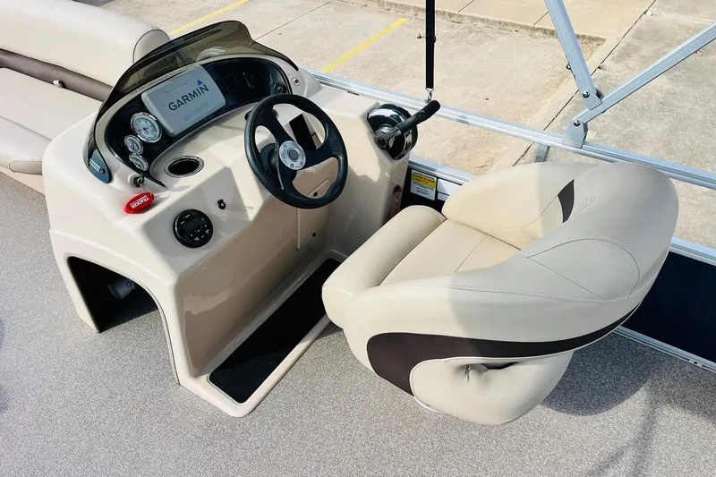 Slide: The Image of 2019 Sun Tracker Party Barge 18 DLX helm with Garmin display and comfortable seating. - 26