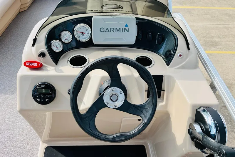 Slide: The Image of 2019 Sun Tracker Party Barge 18 DLX dashboard with Garmin navigation and steering wheel. - 27
