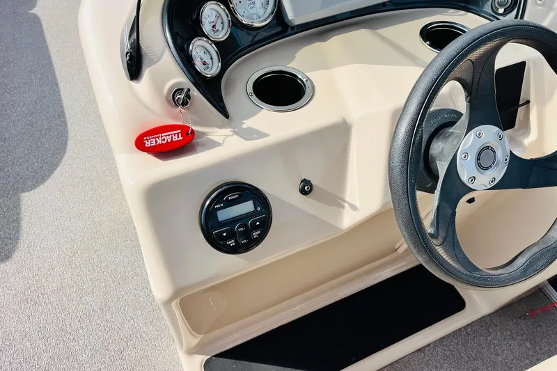Slide: The Image of 2019 Sun Tracker Party Barge 18 DLX steering console with gauges and controls. - 29