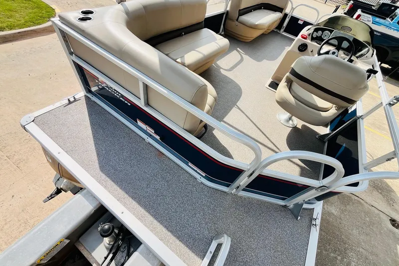 Slide: The Image of 2019 Sun Tracker Party Barge 18 DLX interior with seating and steering console. - 30