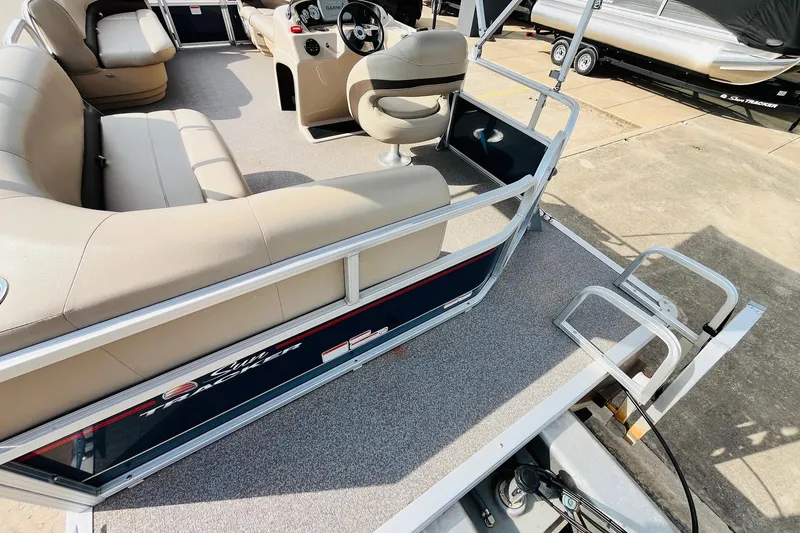 Slide: The Image of 2019 Sun Tracker Party Barge 18 DLX interior with seating and steering console. - 31