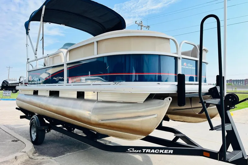 Slide: The Image of 2019 Sun Tracker Party Barge 18 DLX pontoon boat on trailer, side view. - 4