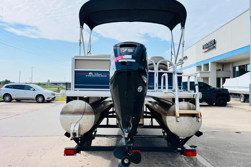 Slide: The Image of 2019 Sun Tracker Party Barge 18 DLX pontoon boat with Mercury 75 engine, parked outside dealership. - 7