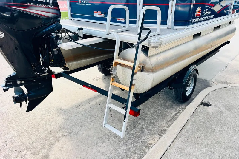 Slide: The Image of 2019 Sun Tracker Party Barge 18 DLX with outboard motor and trailer ladder. - 9