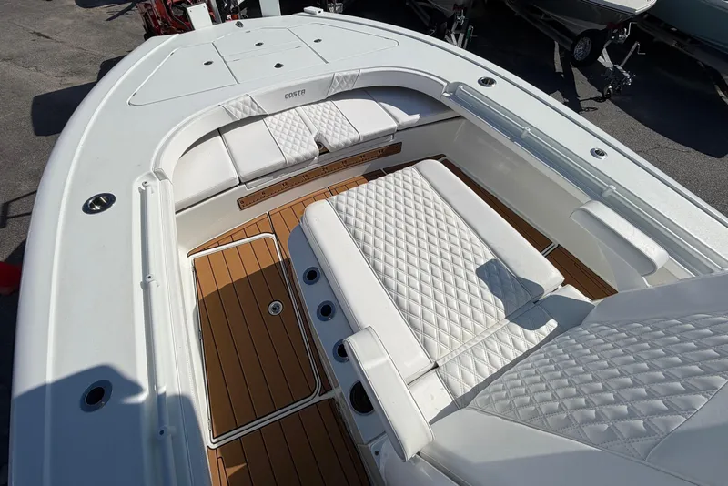 Slide: The Image of 2023 Costa Custom Boats 264 HC with luxurious white seating and teak flooring. - 11