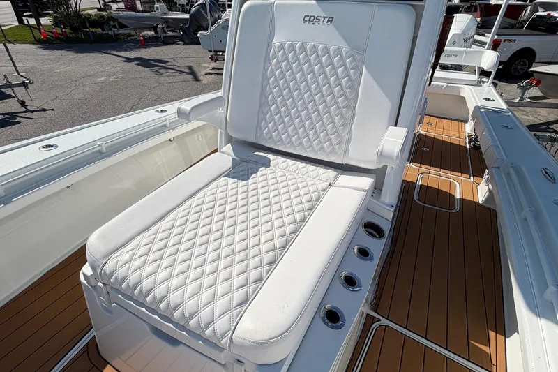 Slide: The Image of Luxurious seating on 2023 Costa Custom Boats 264 HC, featuring diamond-stitched upholstery and teak flooring. - 13