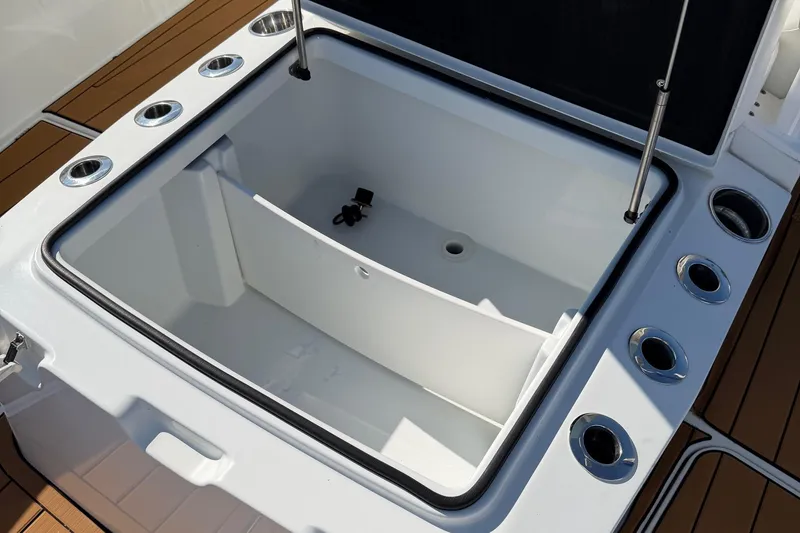 Slide: The Image of 2023 Costa Custom Boats 264 HC livewell with rod holders and open lid. - 14