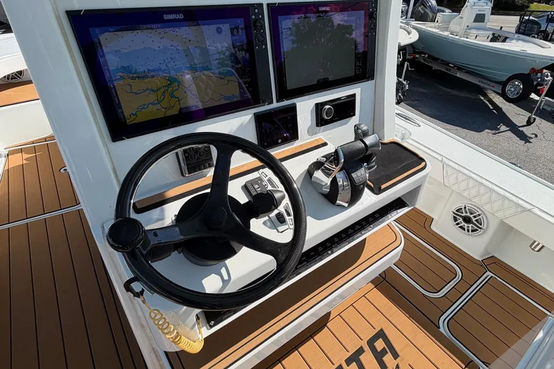 Slide: The Image of 2023 Costa Custom Boats 264 HC helm with dual Simrad displays and teak flooring. - 15