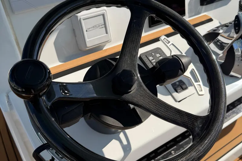 Slide: The Image of Steering wheel and controls of 2023 Costa Custom Boats 264 HC. - 17