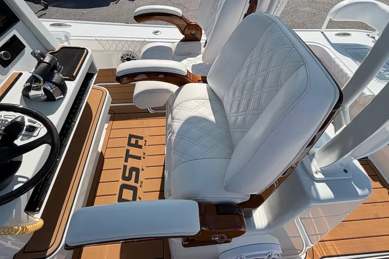 Slide: The Image of Luxurious seating and controls on 2023 Costa Custom Boats 264 HC, featuring elegant design. - 20