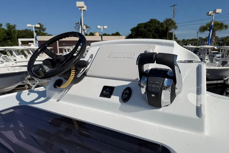Slide: The Image of 2023 Costa Custom Boats 264 HC helm with steering wheel and controls. - 21
