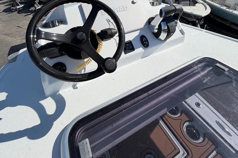Slide: The Image of 2023 Costa Custom Boats 264 HC helm with steering wheel and controls. - 24