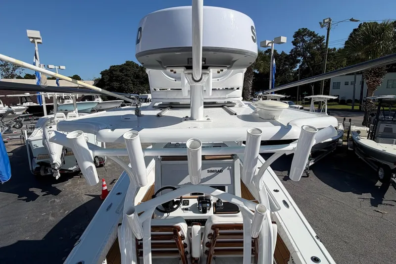 Slide: The Image of 2023 Costa Custom Boats 264 HC, top view showcasing fishing rod holders and navigation equipment. - 27