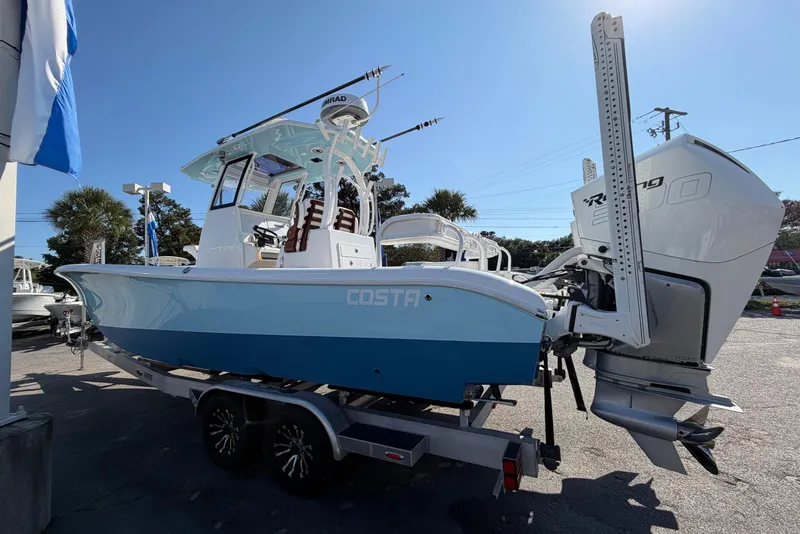 Slide: The Image of 2023 Costa Custom Boats 264 HC, blue hull, on trailer, with powerful outboard engine. - 3