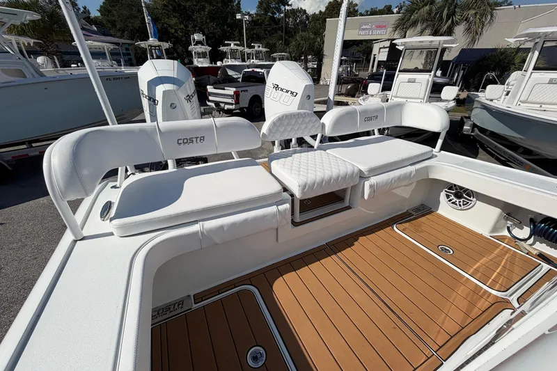 Slide: The Image of 2023 Costa Custom Boats 264 HC with white seating and teak-style flooring. - 32