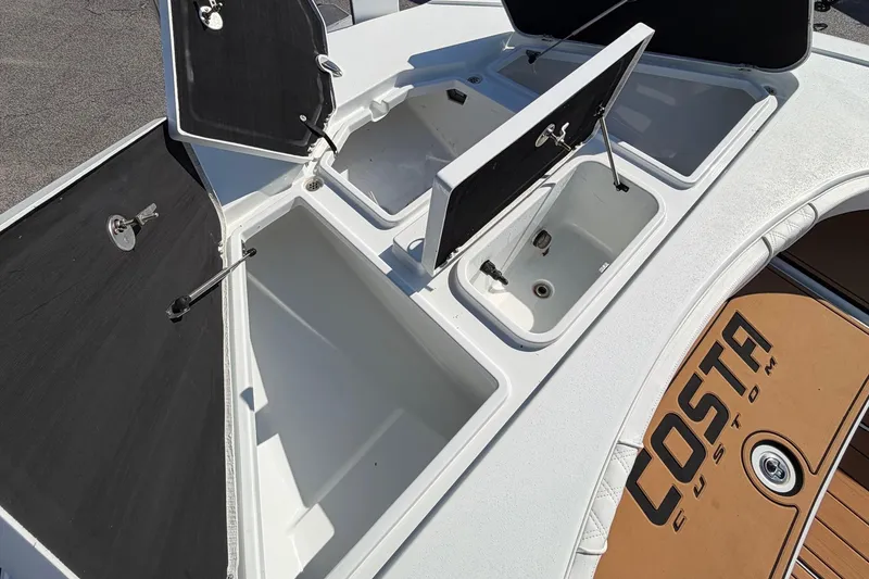 Slide: The Image of 2023 Costa Custom Boats 264 HC with open storage compartments on deck. - 36