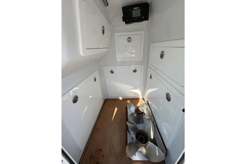 Slide: The Image of Interior of 2023 Costa Custom Boats 264 HC with storage compartments and propellers. - 55