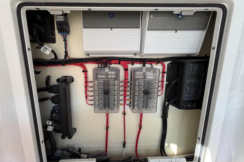 Slide: The Image of Electrical panel of 2023 Costa Custom Boats 264 HC, showcasing wiring and components. - 56