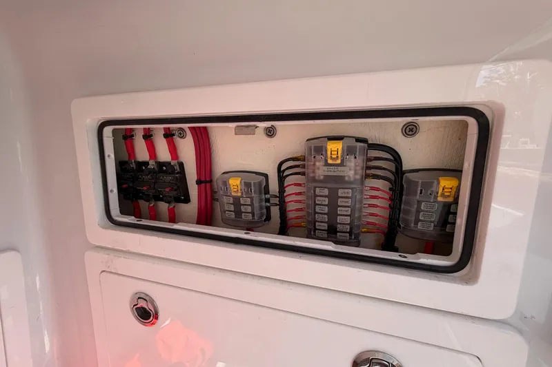 Slide: The Image of Electrical panel of 2023 Costa Custom Boats 264 HC, featuring organized wiring and circuit breakers. - 58