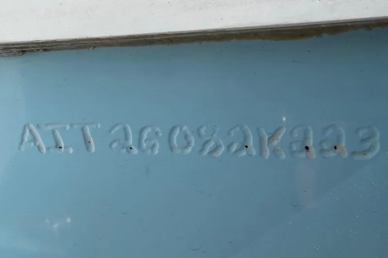 Slide: The Image of 2023 Costa Custom Boats 264 HC hull identification number on light blue surface. - 67