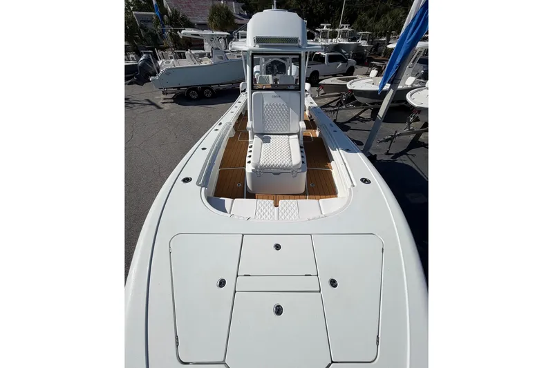 Slide: The Image of 2023 Costa Custom Boats 264 HC, sleek design, spacious deck, modern features, docked outdoors. - 7