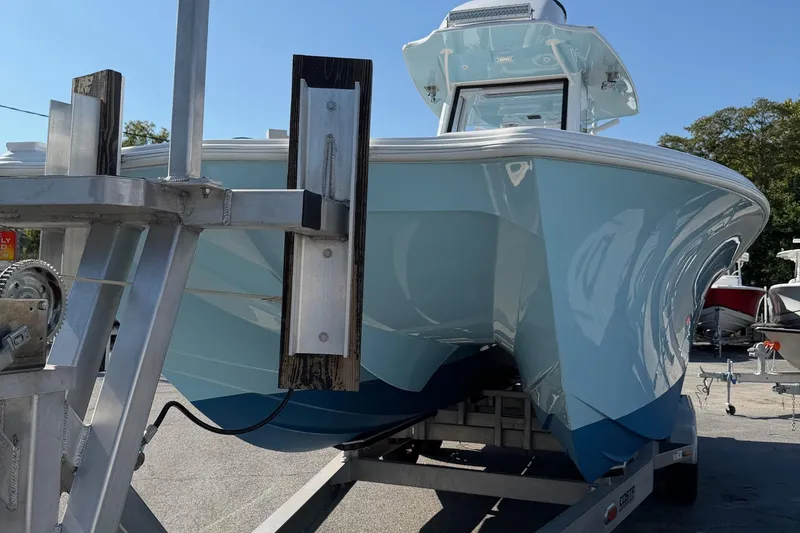 Slide: The Image of 2023 Costa Custom Boats 264 HC on trailer, showcasing sleek design and light blue hull. - 73