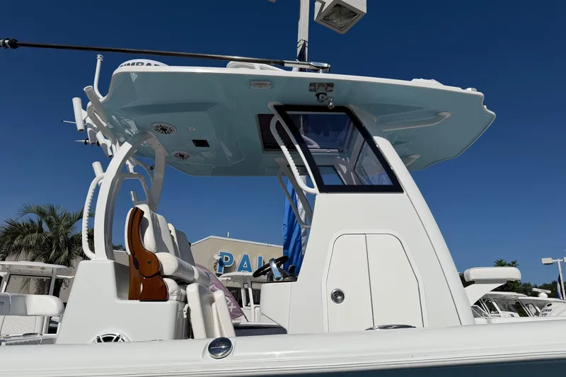 Slide: The Image of 2023 Costa Custom Boats 264 HC, sleek design, white exterior, under clear blue sky. - 8