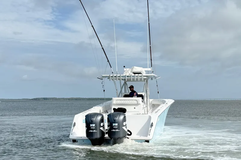 Slide: The Image of 2018 SeaHunter 35 Tournament boat with dual Yamaha V8 engines on open water. - 10