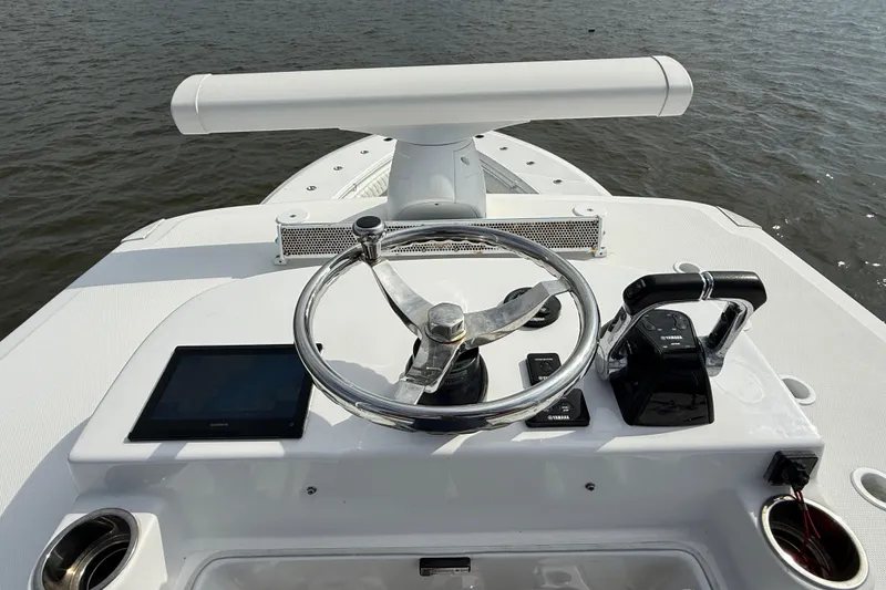 Slide: The Image of 2018 SeaHunter 35 Tournament boat helm with steering wheel and controls on open water. - 101