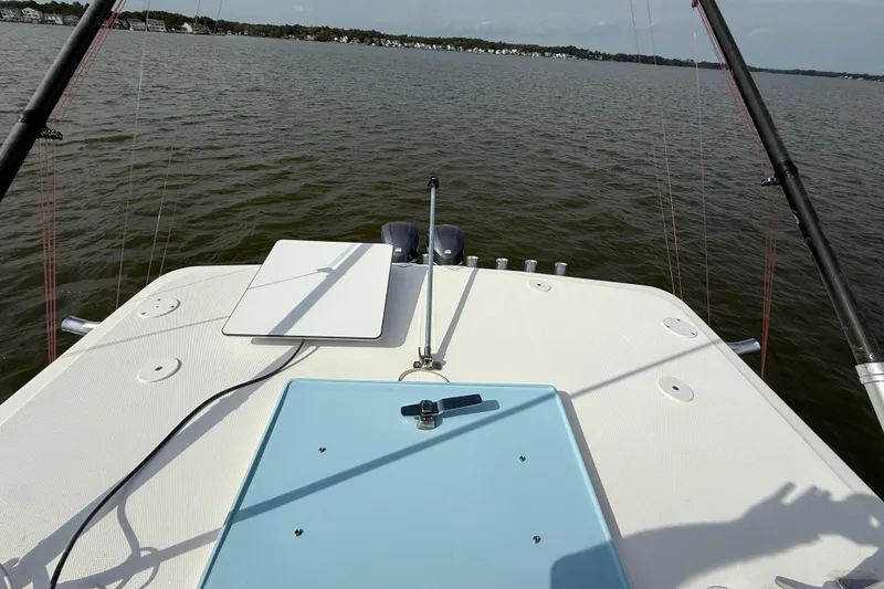 Slide: The Image of 2018 SeaHunter 35 Tournament boat deck with fishing rods on a calm lake. - 102