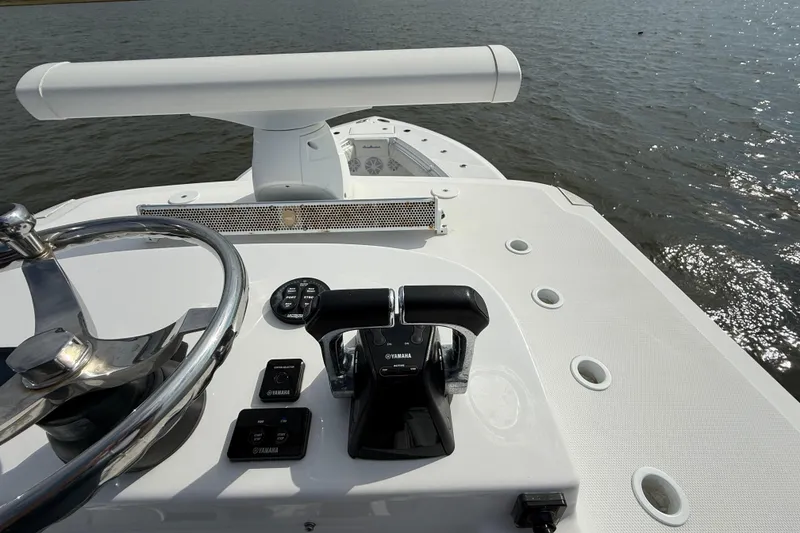 Slide: The Image of 2018 SeaHunter 35 Tournament boat helm with steering wheel and Yamaha controls on water. - 104