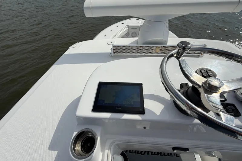 Slide: The Image of 2018 SeaHunter 35 Tournament boat dashboard with steering wheel and navigation display. - 105